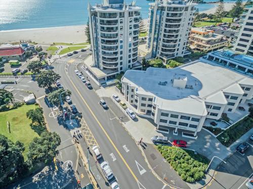 an aerial view of a city with tall buildings and the ocean at Ocean Retreat 228 in Mount Maunganui