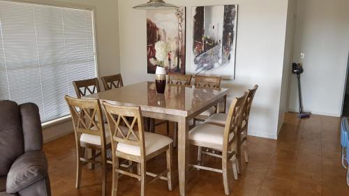 a dining room with a table and chairs at 505a CONROD STRAIGHT MOUNT PANORAMA in Bathurst