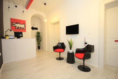 a living room with two chairs and a tv at The Hostel in Zadar