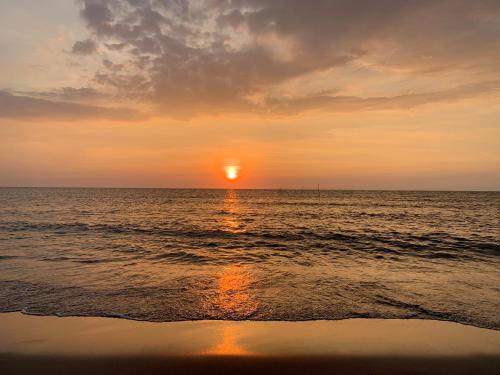 a sunset over the ocean with the sun setting at Squareville Subdivision in San Fernando