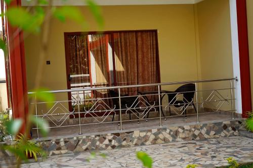 a balcony with two chairs and a window at RJ Mahaal Hotel in Kilinochchi
