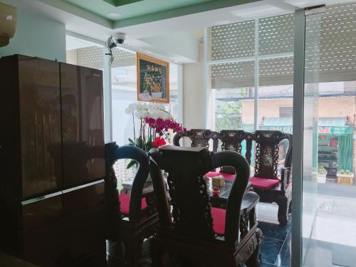 a group of chairs in a room with a window at Hotel thanh vinh in Ho Chi Minh City