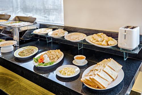 a buffet line with different types of food on plates at Ocean Haven Hotel in Da Nang