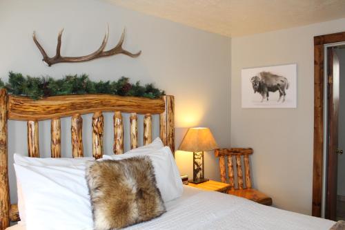 a cat sitting on top of a bed at The Evergreen in West Yellowstone