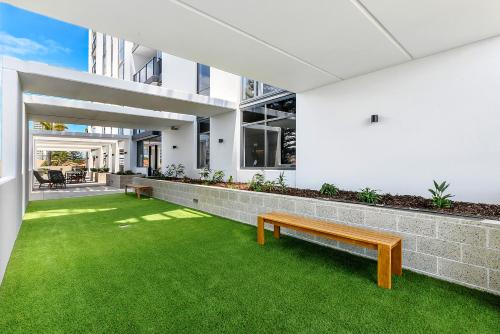 an indoor garden with a bench and grass at Qube Broadbeach in Gold Coast
