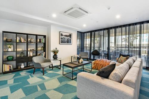 a living room with a couch and a table at Qube Broadbeach in Gold Coast