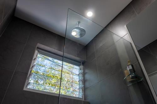 ein Badezimmer mit Dusche und Fenster in der Unterkunft Hideaway Haven, The Cute Place To Put Up Your Feet in Sydney