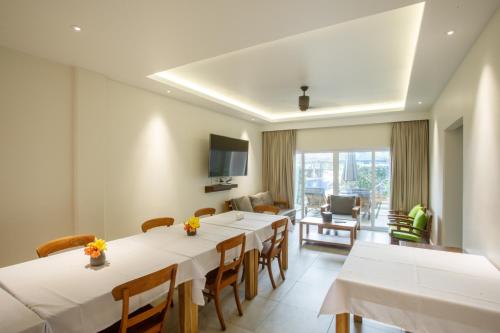 a conference room with tables and chairs and a television at Cove Resort Palau in Koror