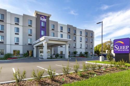 a hotel building with a sign in front of it at Sleep Inn & Suites Tampa South in Tampa