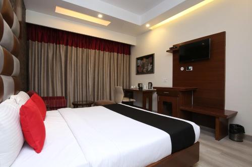 a hotel room with a bed and a desk at Hotel Shagun Chandigarh Zirakpur in Chandīgarh