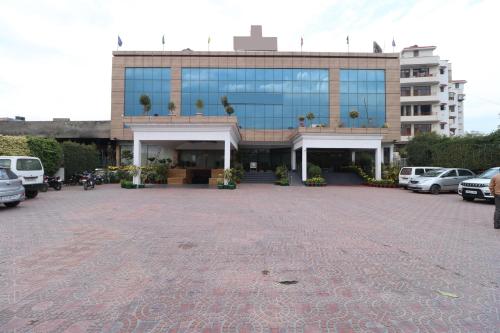 a large building with cars parked in front of it at Hotel Shagun Chandigarh Zirakpur in Chandīgarh