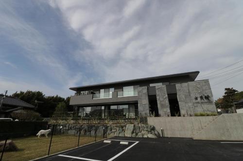 a building with a parking lot in front of it at Yado Hanasaku in Tateyama