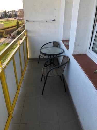 a small table and a chair on a balcony at Apartament Przy Skarpie in Toruń