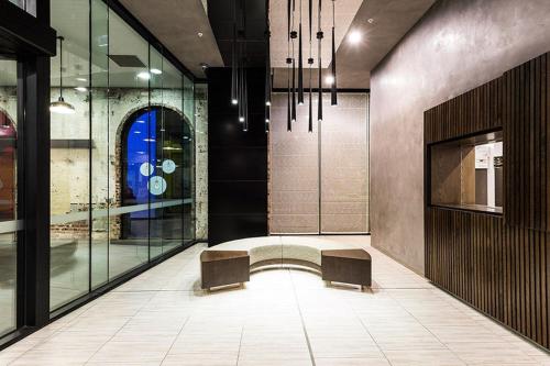 a lobby with two benches and glass walls at WOW Apartment on Spencer in Melbourne