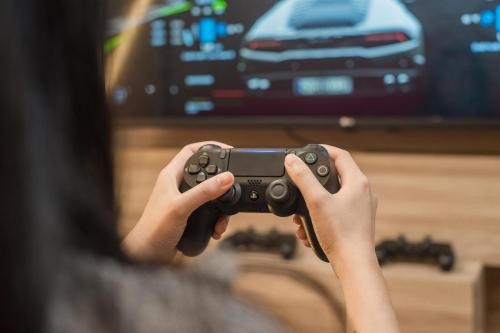 a person playing a video game with a controller at Vib Best Western Sanam Pao in Bangkok