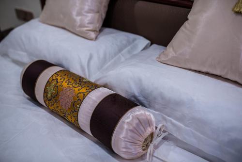 a towel laying on top of a bed at Hainan Jingshan Hotel in Haikou