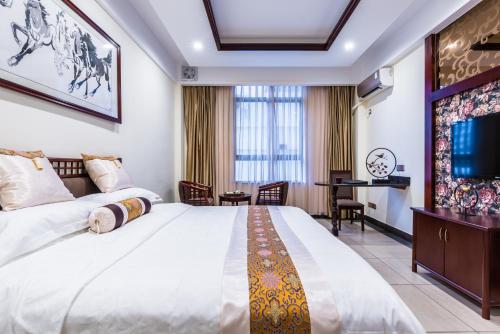 Postel nebo postele na pokoji v ubytování Hainan Jingshan Hotel