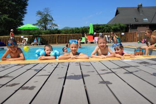 a group of babies laying in a swimming pool at Camping Domaine du Lac Chambon in Murol