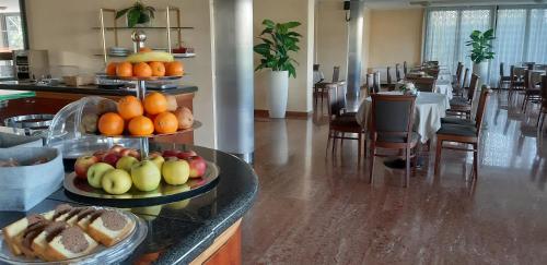 a buffet in a hotel with fruit on plates at Residence all'Adige in Verona