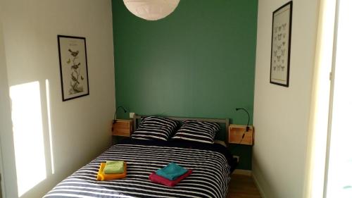 a bedroom with a bed with two pillows on it at Maison Cahors in Cahors