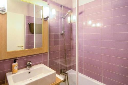 a purple bathroom with a sink and a shower at La bulle de Lily in Moliets-et-Maa