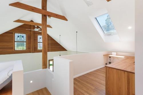 a room with white walls and wood floors and a staircase at 275 Ridge Road Central Tilba in Central Tilba