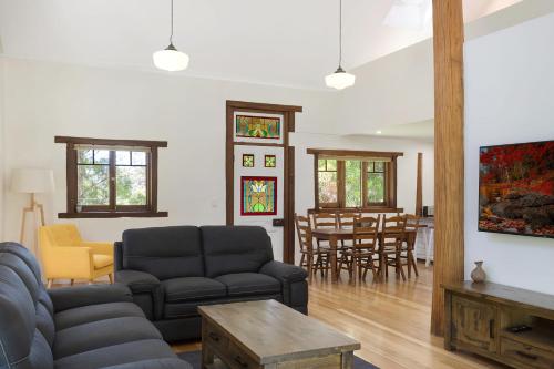 a living room with a couch and a table at 275 Ridge Road Central Tilba in Central Tilba