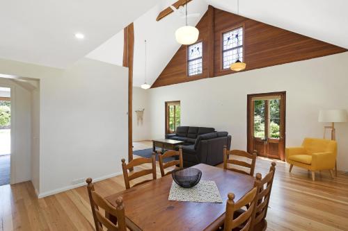 a living room with a table and a couch at 275 Ridge Road Central Tilba in Central Tilba