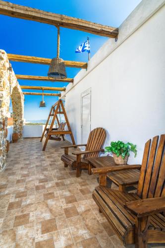 a patio with two chairs and a table at Limeri Traditional Guest House in Monólithos