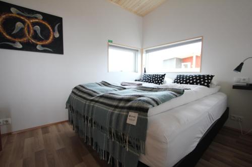 a bedroom with a large bed in a room at Blue View Cabin 7A With private hot tub in Reykholt