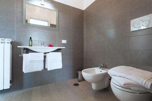 a bathroom with a white toilet and a sink at Elements Guest House in Rome