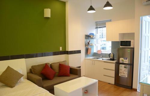a living room with a couch and a kitchen at Saigon Apartments 2 in Ho Chi Minh City