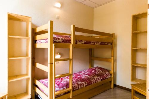 a room with three bunk beds in a room at Village Vacances Le Salvagny in Sixt