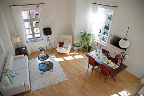 an overhead view of a living room with a table and chairs at Four Streets Athens - Luxury Suites Apartments in Athens in Athens
