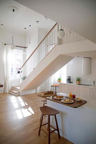 a kitchen with a staircase and a table with food at Four Streets Athens - Luxury Suites Apartments in Athens in Athens
