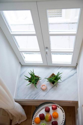 a skylight in a room with a plate of fruit at Four Streets Athens - Luxury Suites Apartments in Athens in Athens