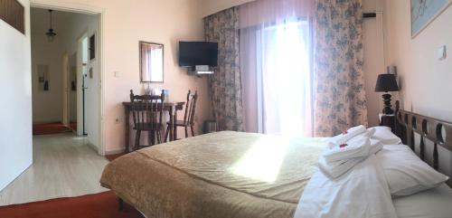 a bedroom with a large bed and a window at Chris Studios & Apartments in Lechaio