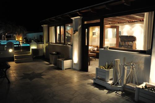 a patio lit up at night with at Perissa Bay in Perissa