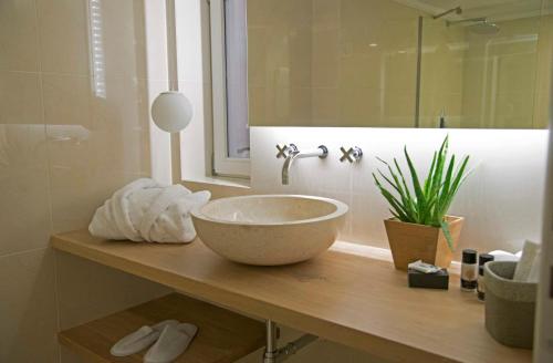 a bathroom with a large bowl sink on a counter at Four Streets Athens - Luxury Suites Apartments in Athens in Athens