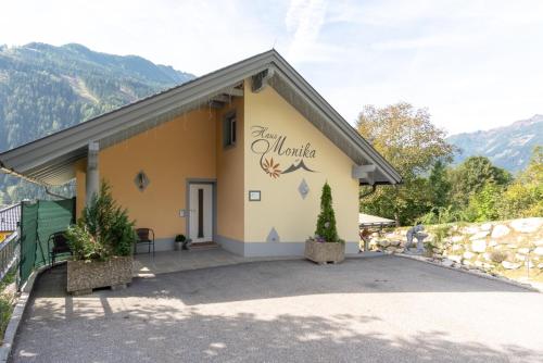 a building with a sign on the side of it at Appartementhaus Monika in Flattach