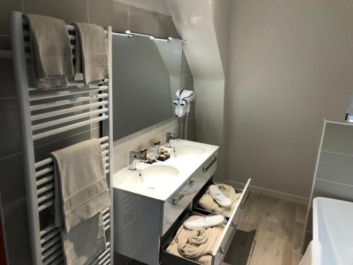 a bathroom with a sink and a mirror at Domaine Plessis Gallu - vacation cottage rental in Azay-le-Rideau