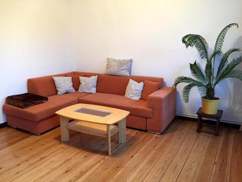 a living room with a couch and a table at Ferienwohnung Marta in Altefähr