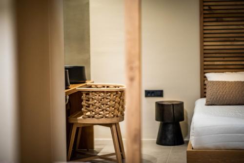 a room with a bed and a stool in a room at San Giorgio in Fira
