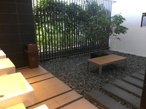 a bathroom with a bench and a fence at Woodsbury Suites 7722 Butterworth Penang in Butterworth