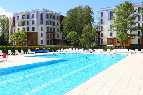 a large swimming pool with people in the water at KOLOBRZEG apartamenty GREG POLANKI in Kołobrzeg