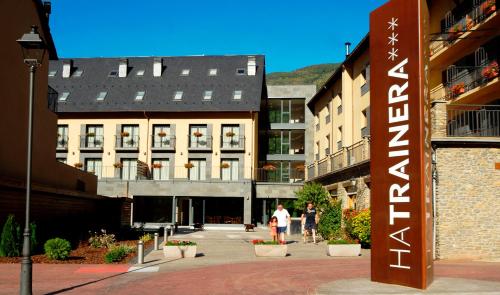a group of people walking in a courtyard of a building at Apartaments Trainera in Esterri d'Àneu