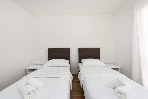 Posteľ alebo postele v izbe v ubytovaní July Apartment