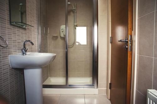 a bathroom with a sink and a shower at Lough Currane Holiday Homes in Waterville