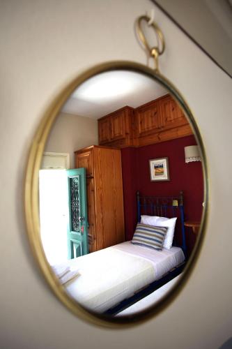 a mirror reflection of a bed in a bedroom at SeaMe Houses in Symi