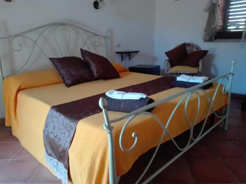 a bedroom with a bed with a metal frame at Il Vigneto B&B in Gonnesa